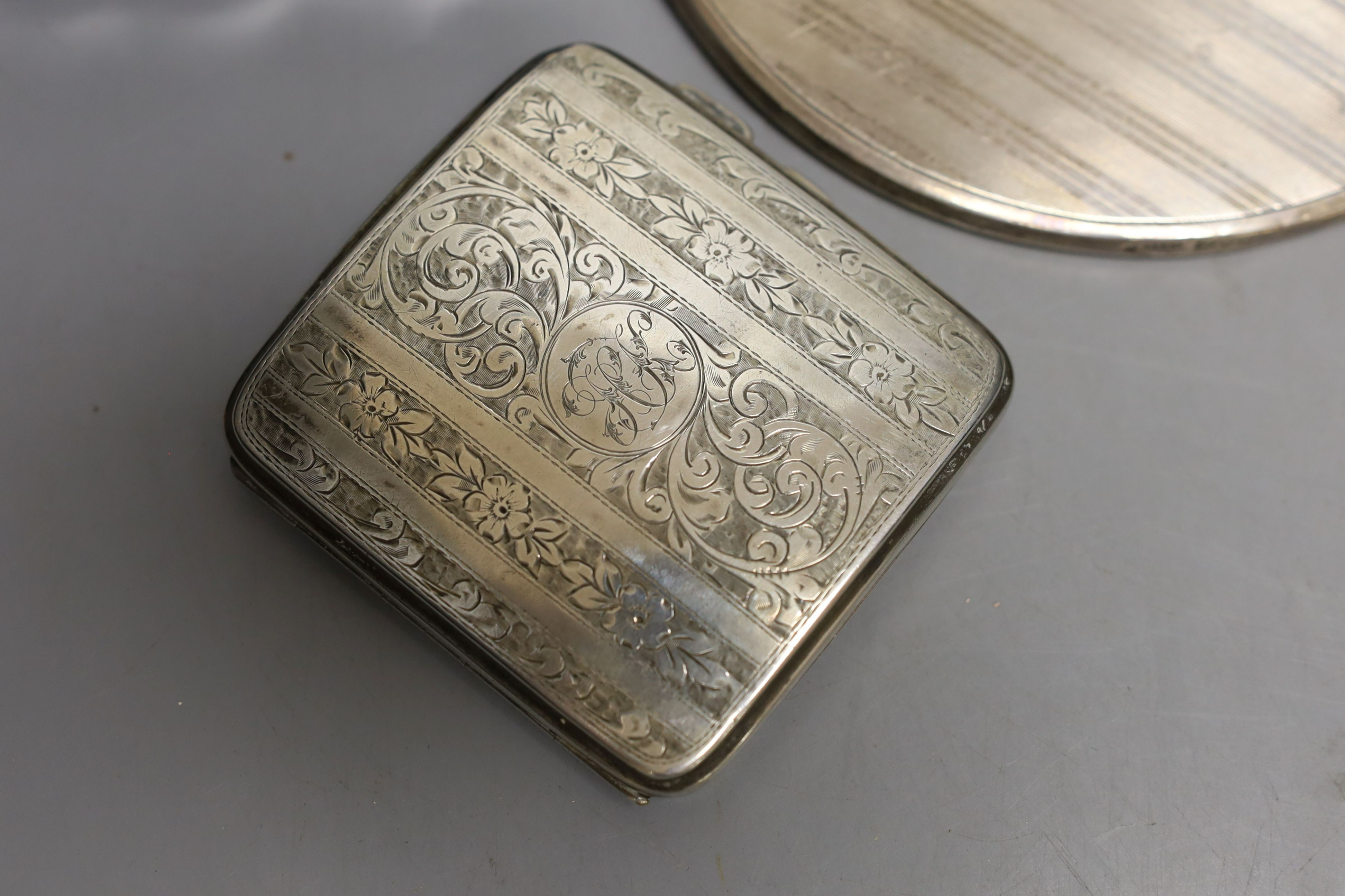 An Art Deco silver mounted cigarette box, a silver cigarette box, silver trinket box and a silver mounted hand mirror.